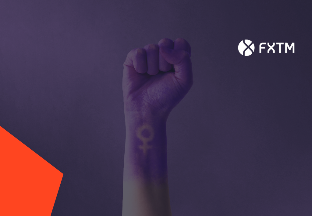 womens hand dipped in purple paint with female symbol on wrist