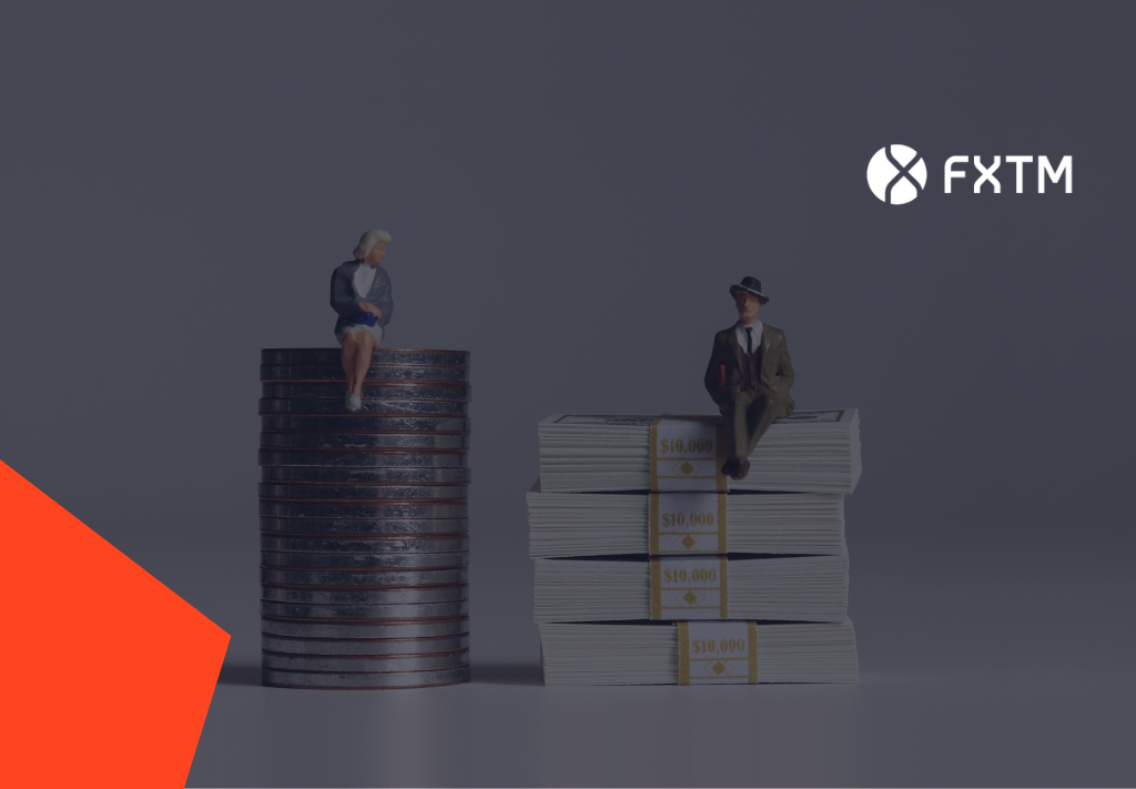 miniature model of man and woman perched on money